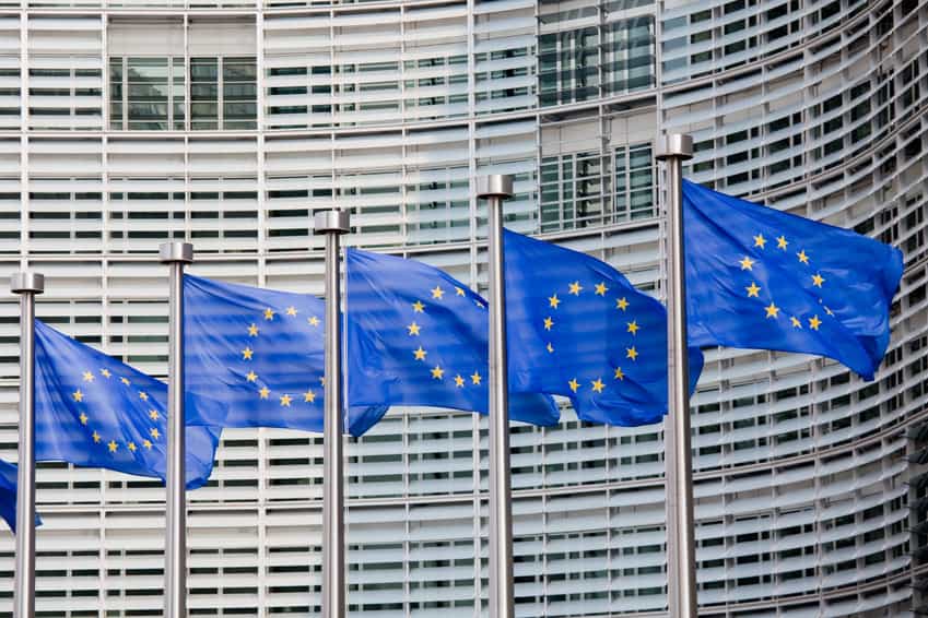 European Union flags waving in front of building.